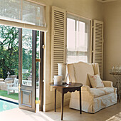 Elegant sitting room with view to pool in garden through open door