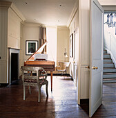 White music room with harpsichord and chair