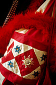 Decorative red and white mirror and patchwork bag from India with red feather boa