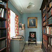 Library studio with mahogany bookcase and tapestry armchair