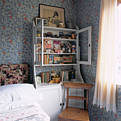 Country bedroom with William Morris style wallpaper and off-white dresser