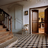 Grand entrance hallway in a French chateau with black and white tilled stone floors