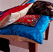Brightly coloured silk brocade cushions with 1950's embroidery on modern daybed