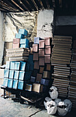 Stacks of boxes in an alleyway in the medina Fez Morocco