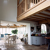 Open plan country kitchen dining room with mezzanine and stone floor