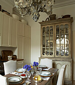 Classical style kitchen with dining table prepared for meal
