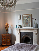 Bedroom detail with antique furnishings in London townhouse, UK