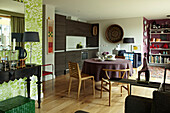 Open plan kitchen dining and living space with collection of contemporary art and crafts on display 