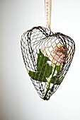 Single stem rose in a metal heart