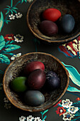 Bowls of dyed eggs on floral fabric