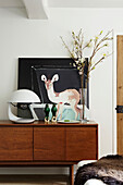 Vintage retro sideboard with a collection and display of homeware and picture