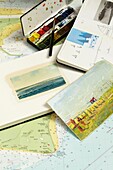 Postcards maps and sketch books and paints