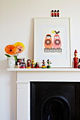 Russian dolls and artwork on mantlepiece in girl's bedroom of London townhouse, England, UK