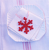 Red snowflake decoration on a napkin