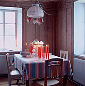 Festive Christmas decorations around a table setting in wooden chalet interior