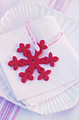 Red snowflake decoration with ribbon