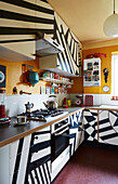 Black and white abstract geometric pattern on fitted units in Hackney kitchen, East London, UK