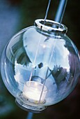 Spherical glass lantern with tea light inside