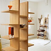 Wooden shelving unit with coloured glass ornaments