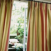 Striped curtains with open doorway and steps to garden