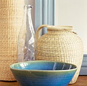 Rattan containers with glass bottle and ceramic bowl