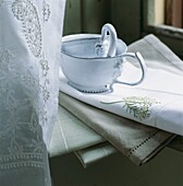 Metal jugs on embroidered napkins with antique lace