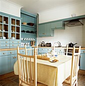 tea tray on table in kitchen with contrasting tablecloth and cupboard units