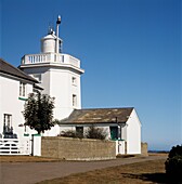 Whitewashed lighthouse and outbuildings