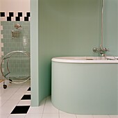 Green pastel coloured bathroom with partitioning shelf