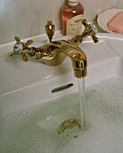 Water running from brass mixer taps