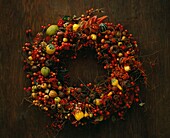 Thanksgiving wreath made of twigs red berries and fruits