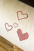 Red heart shape embroidery on white material