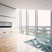 Minimalist penthouse kitchen with picture windows and stairwell