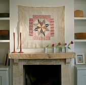 American quilt above fireplace in living room