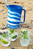Mojito served in cups on beach