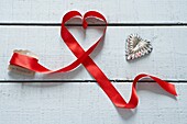 Red ribbon and silver heart shapes