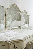 Bedroom suite in neutral white decor with deer model on dressing table symbol of gentleness and love