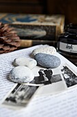 Desk with pebbles,a letter and some black and white family photos