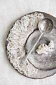 Silver spoon on plate with lace