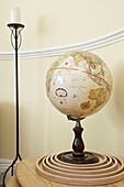 World globe and candle in cream room with dado rail