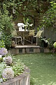 Garden furniture on raised terrace in London garden   UK