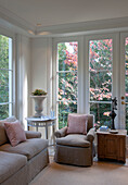 Armchair and sofa in garden room of contemporary Washington DC home,  USA