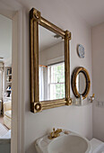 Gilt framed mirrors above wash basin in Washington DC home,  USA