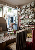 Cushions for sale in doorway of tea salon,  Dordogne,  France
