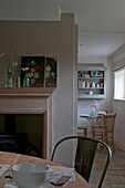 Artwork and cut flowers in kitchen dining room of Kingston home,  East Sussex,  England,  UK