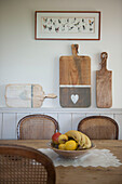 Chopping boards on dad with wicker chairs at table in Dordogne farmhouse  Perigueux  France