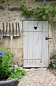 Wooden gardening fork at gate with carved heart in the Dordogne  Perigueux  France
