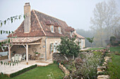 Shaded terrace exterior of rural Dordogne cottage  Perigueux  France