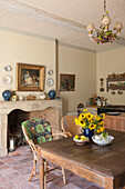 Sunflowers on wooden table with exposed brick fireplace in Dordogne cottage kitchen  Perigueux  France