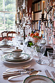 White crockery and silverware with glass candelabras in London home  England  UK